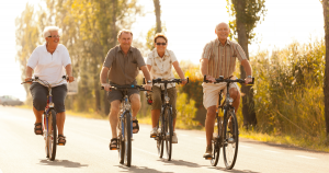 Retirees enjoying a bicycle ride inside a mobile home community park